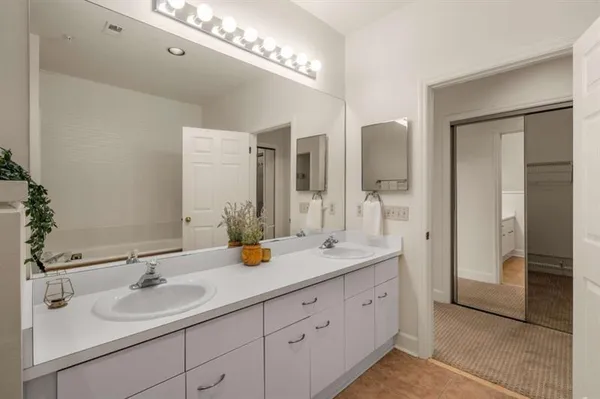 a bathroom with a double vanity sink and a mirror