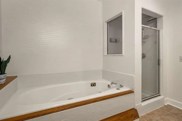 a bathroom with a bathtub and a shower