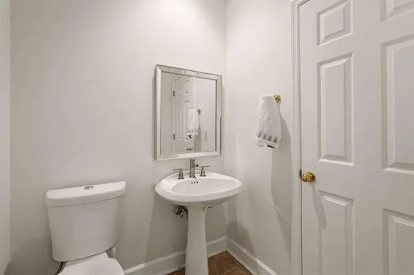 a bathroom with a sink a mirror and a toilet