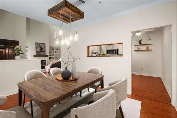 a view of a dining room with furniture and wooden floor