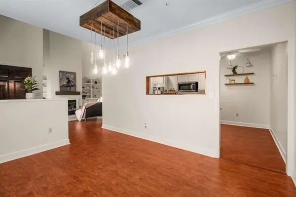 a view of a kitchen with a sink refrigerator and wooden floor