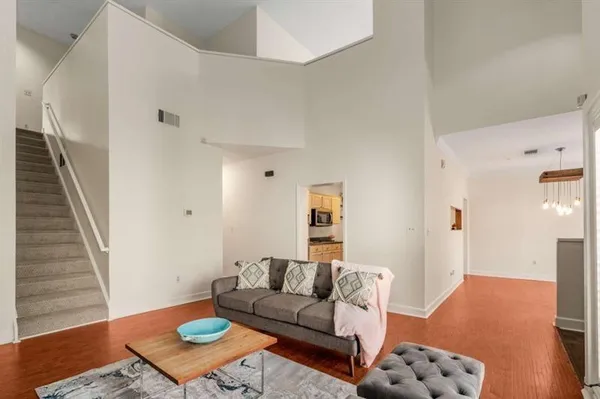 a living room with furniture and wooden floor