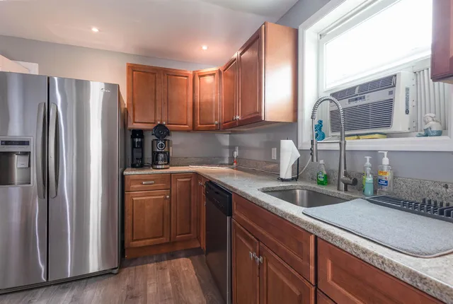 a kitchen with a sink refrigerator and cabinets