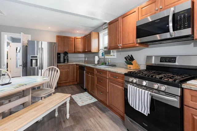 a kitchen with a stove a sink and a microwave