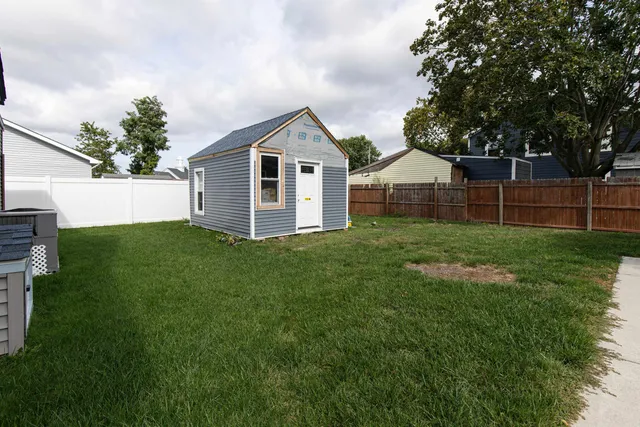 a backyard of a house with table and chairs