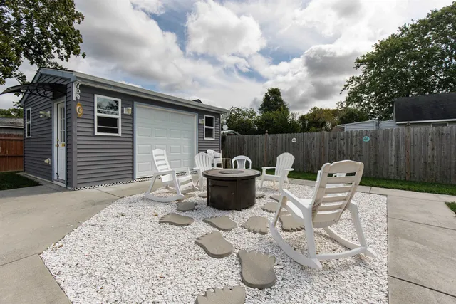 a front view of a house with swimming pool having outdoor seating