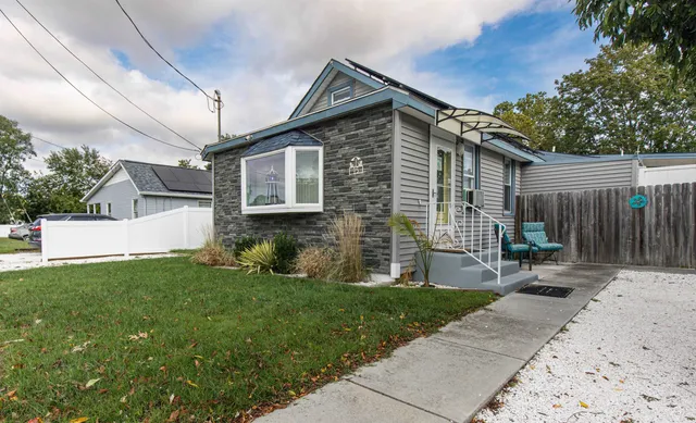 a front view of a house with a garden