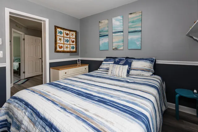 a bedroom with a bed and a night stand