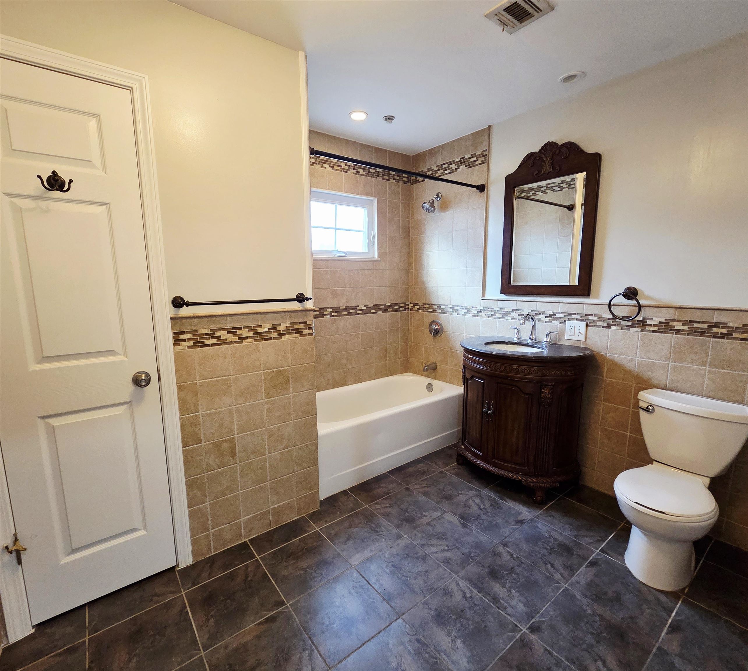 141 68th Street, Unit 7 Guttenberg, NJ 07093 - Photo 6 of 9 a bathroom with a granite countertop sink toilet and shower