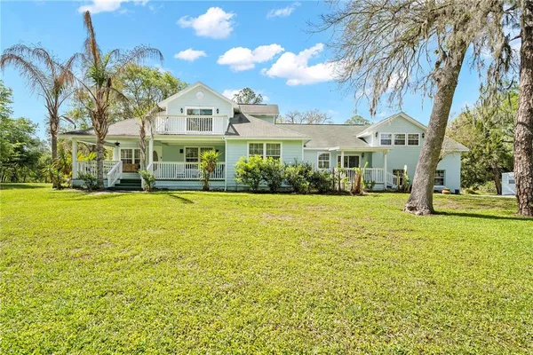 a front view of house with yard and green space