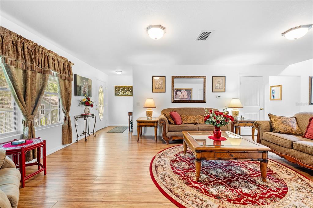 7347 Packingham Drive Webster, FL 33597 - Photo 13 of 75 a living room with furniture or couch and a wooden floor