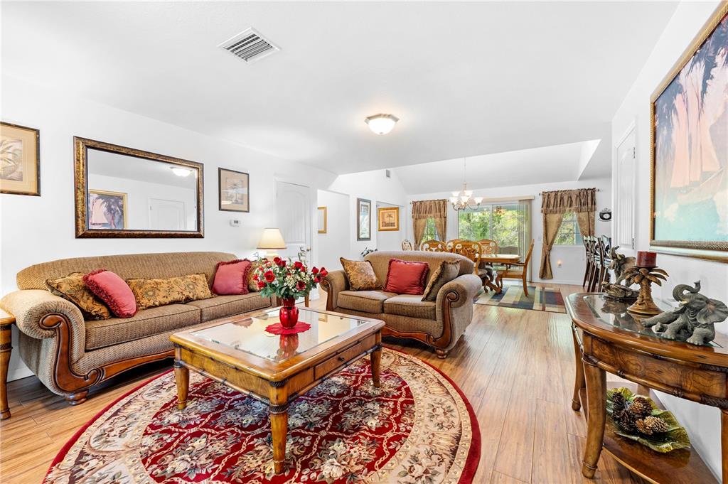 7347 Packingham Drive Webster, FL 33597 - Photo 14 of 75 a living room with furniture a rug and a large window