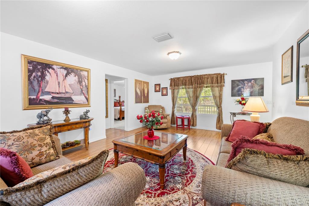 7347 Packingham Drive Webster, FL 33597 - Photo 16 of 75 a living room with furniture and a large window