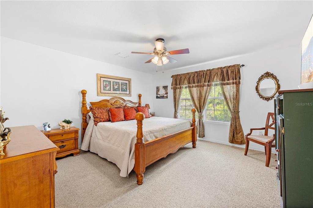 7347 Packingham Drive Webster, FL 33597 - Photo 17 of 75 a bed room with a bed and a chandelier