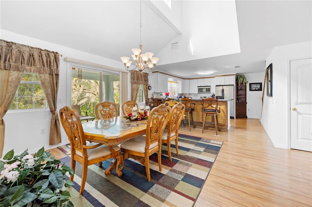 7347 Packingham Drive Webster, FL 33597 - Photo 23 of 75 a view of a dining room with furniture and wooden floor