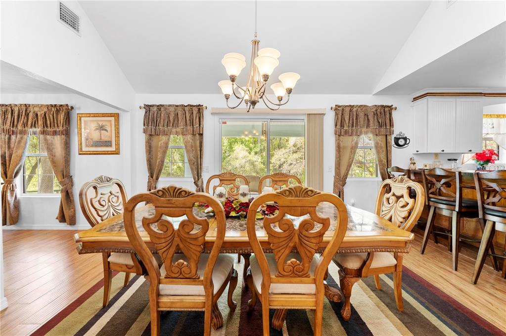 7347 Packingham Drive Webster, FL 33597 - Photo 24 of 75 a view of a dining room with furniture a chandelier and wooden floor