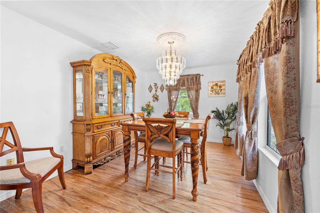 7347 Packingham Drive Webster, FL 33597 - Photo 26 of 75 a view of a dining room with furniture and wooden floor