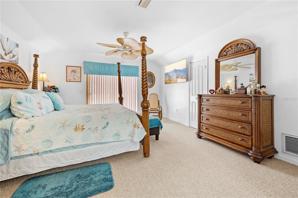 7347 Packingham Drive Webster, FL 33597 - Photo 41 of 75 a bedroom with a bed and a dresser