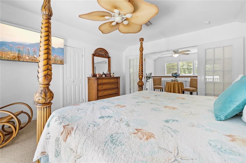 7347 Packingham Drive Webster, FL 33597 - Photo 43 of 75 a bedroom with a bed dresser and a chandelier