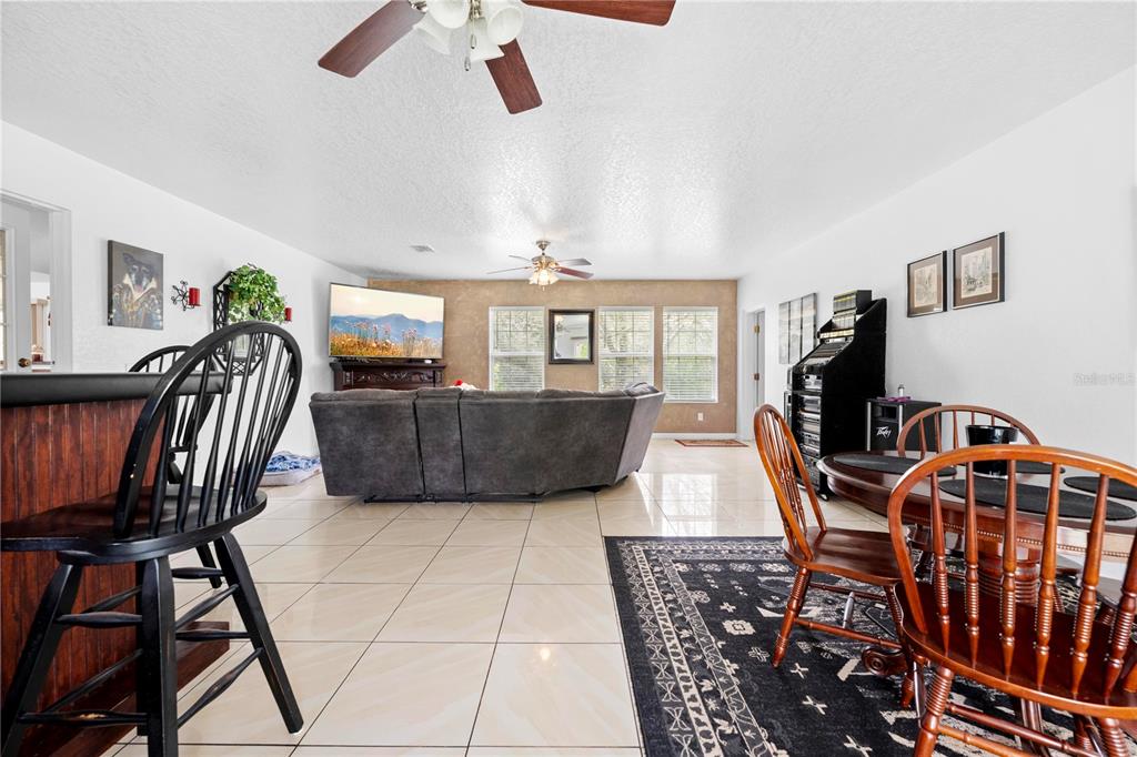7347 Packingham Drive Webster, FL 33597 - Photo 50 of 75 a view of a livingroom with furniture a flat screen tv and a book shelf