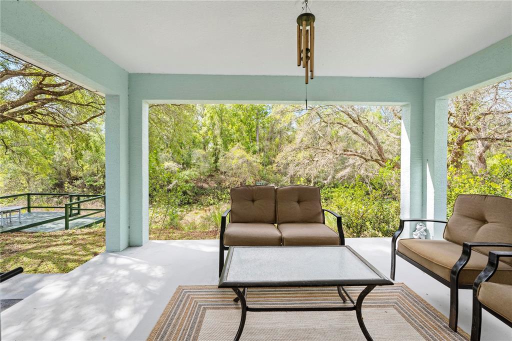 7347 Packingham Drive Webster, FL 33597 - Photo 58 of 75 a living room with furniture and a floor to ceiling window