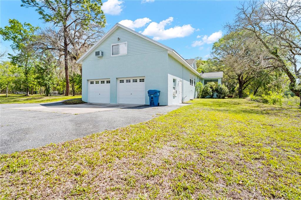 7347 Packingham Drive Webster, FL 33597 - Photo 66 of 75 a view of a house with a yard and potted plants