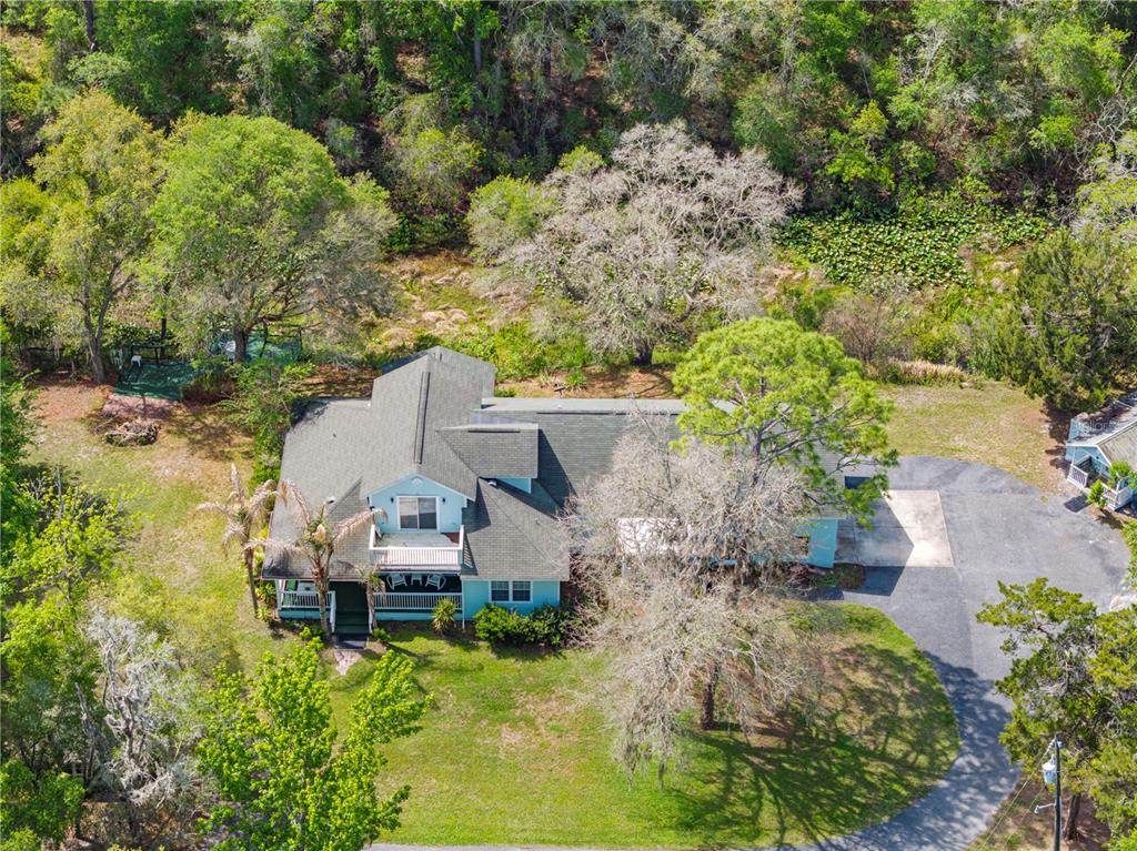 7347 Packingham Drive Webster, FL 33597 - Photo 69 of 75 an aerial view of a house with a yard and lake view