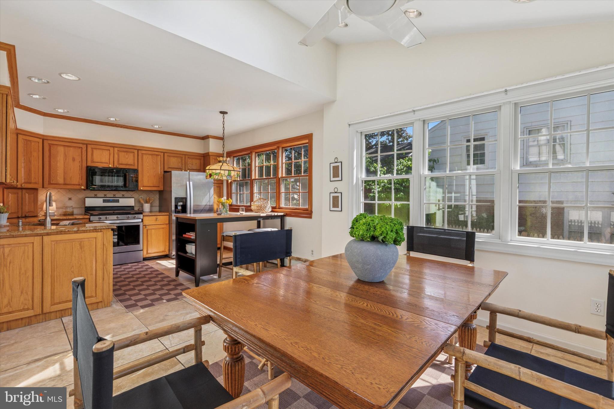 508 Baird Road Merion Station, PA 19066 - Photo 11 of 52 a kitchen with a table chairs refrigerator and microwave