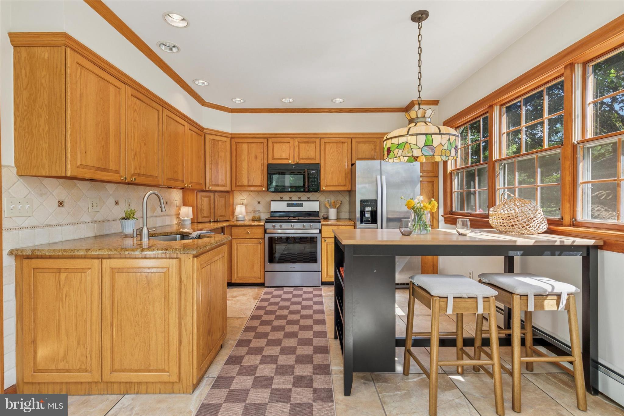 508 Baird Road Merion Station, PA 19066 - Photo 15 of 52 a kitchen with stainless steel appliances granite countertop a stove and a refrigerator