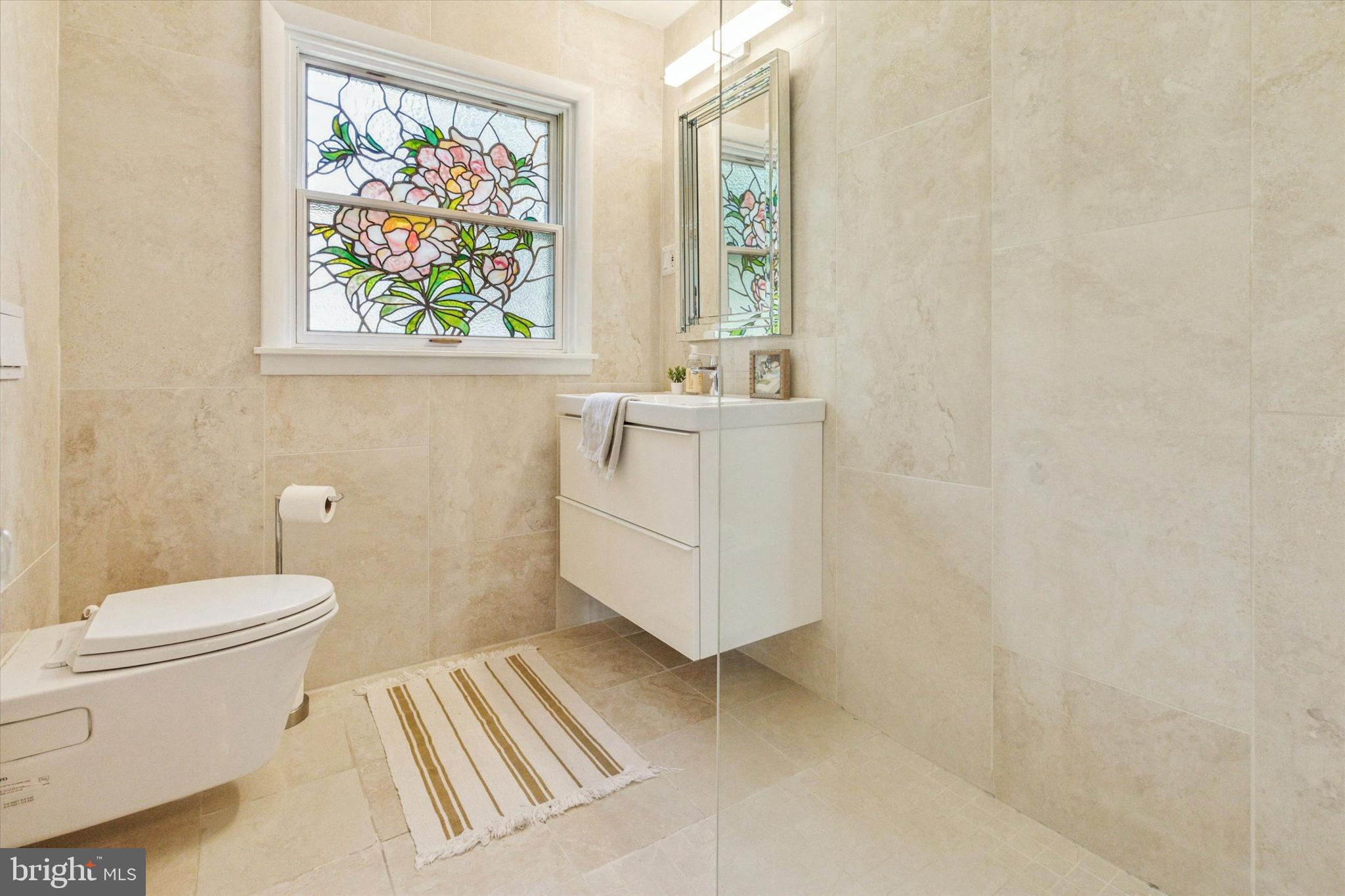 508 Baird Road Merion Station, PA 19066 - Photo 33 of 52 a bathroom with a sink a toilet and painting on the wall