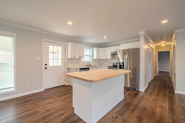 a kitchen with a stove a sink and a refrigerator