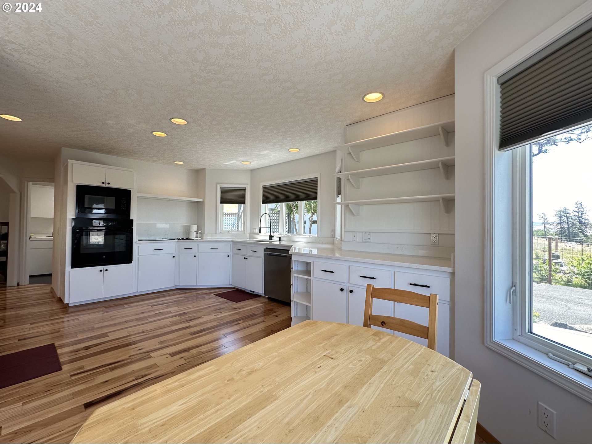 110 Eagle Drive Goldendale, WA 98620 - Photo 20 of 48 a large kitchen with kitchen island a sink dishwasher stove and oven with wooden floor