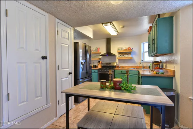 a kitchen with a table and chairs