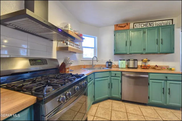 a kitchen with a stove top oven sink and cabinets