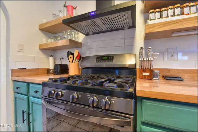 a kitchen with stainless steel appliances granite countertop a stove and a sink