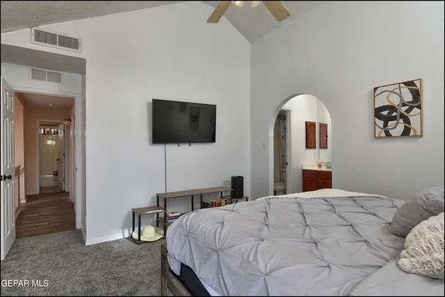 a bedroom with a bed and a flat screen tv