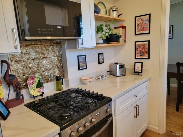 a kitchen with a stove and cabinets
