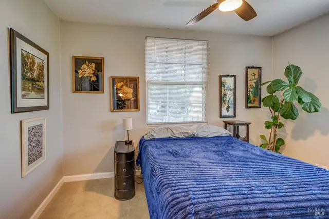a bed sitting in a bedroom next to a window