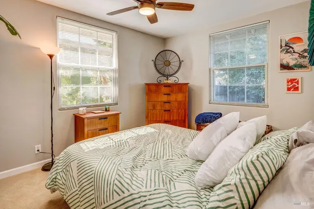 a bedroom with a bed a dresser and a window