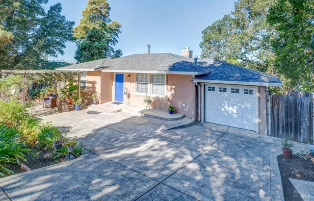 a front view of a house with a yard and a garage