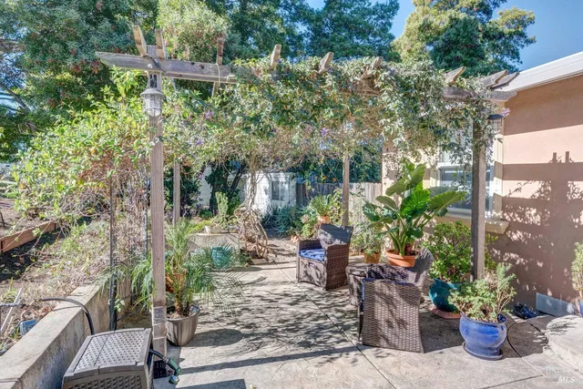 a view of a house with sitting area and garden