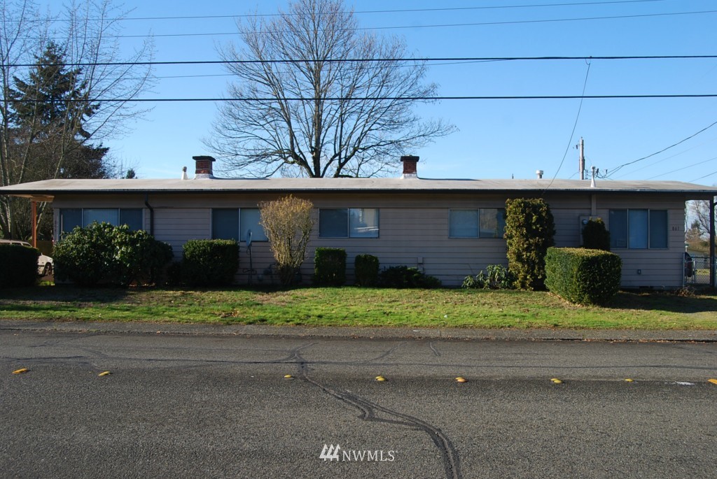 859 Edmonds Avenue Northeast Renton, WA 98056 - Photo 1 of 22 a front view of a house with a yard and a garage