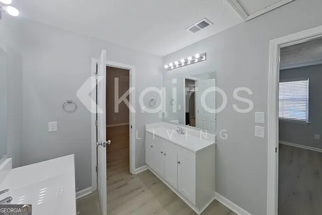 a bathroom with a sink a mirror and a shower