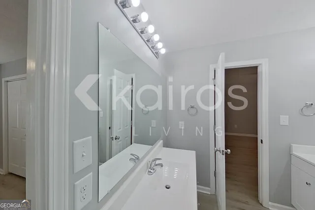 a bathroom with a tub a sink and mirrors