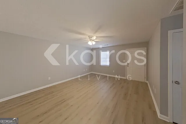 a view of room with window and hardwood floor