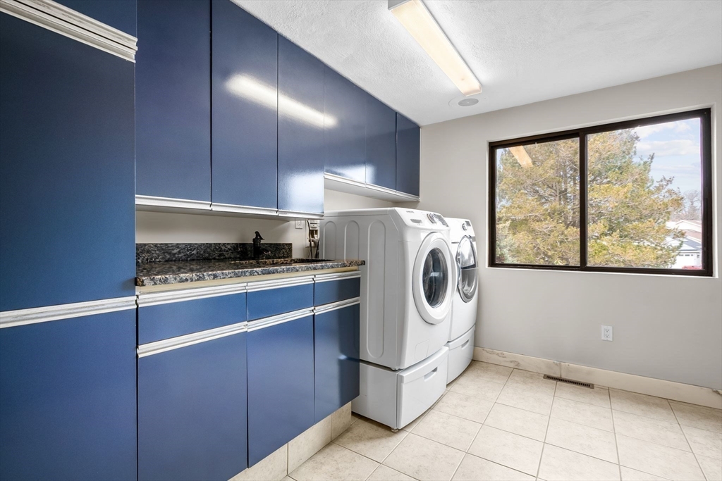 4 Rockland Terrace Saugus, MA 01906 - Photo 15 of 42 a kitchen with a refrigerator and washer