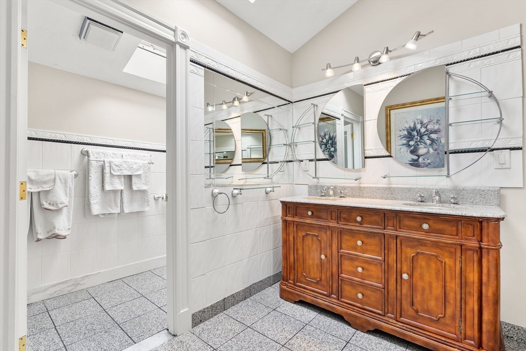 4 Rockland Terrace Saugus, MA 01906 - Photo 22 of 42 a bathroom with a sink a mirror and a shower