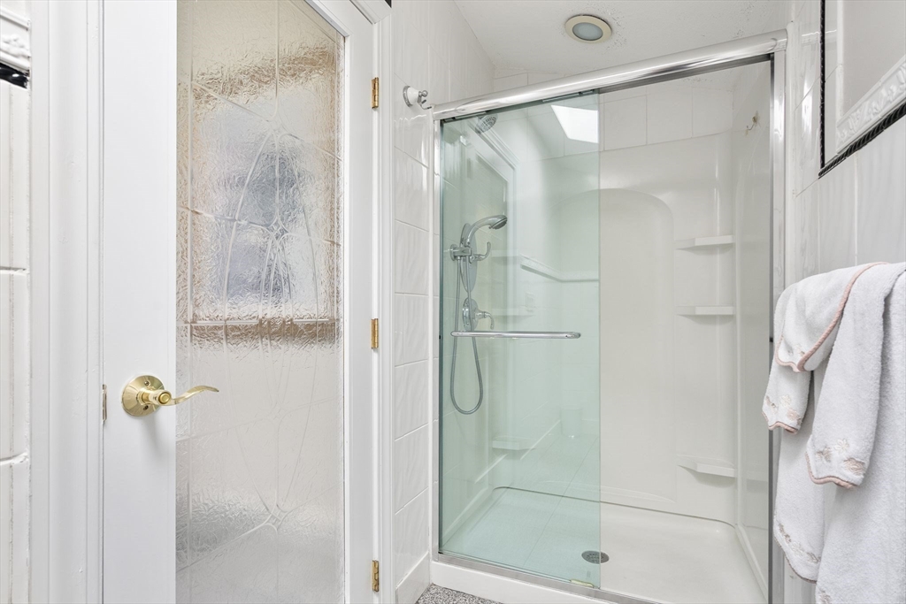 4 Rockland Terrace Saugus, MA 01906 - Photo 23 of 42 a bathroom with a glass shower door
