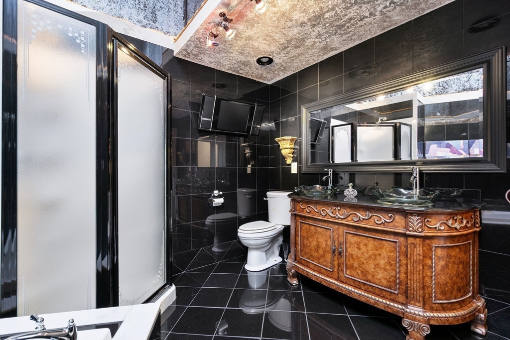 4 Rockland Terrace Saugus, MA 01906 - Photo 26 of 42 a bathroom with a sink a toilet and shower