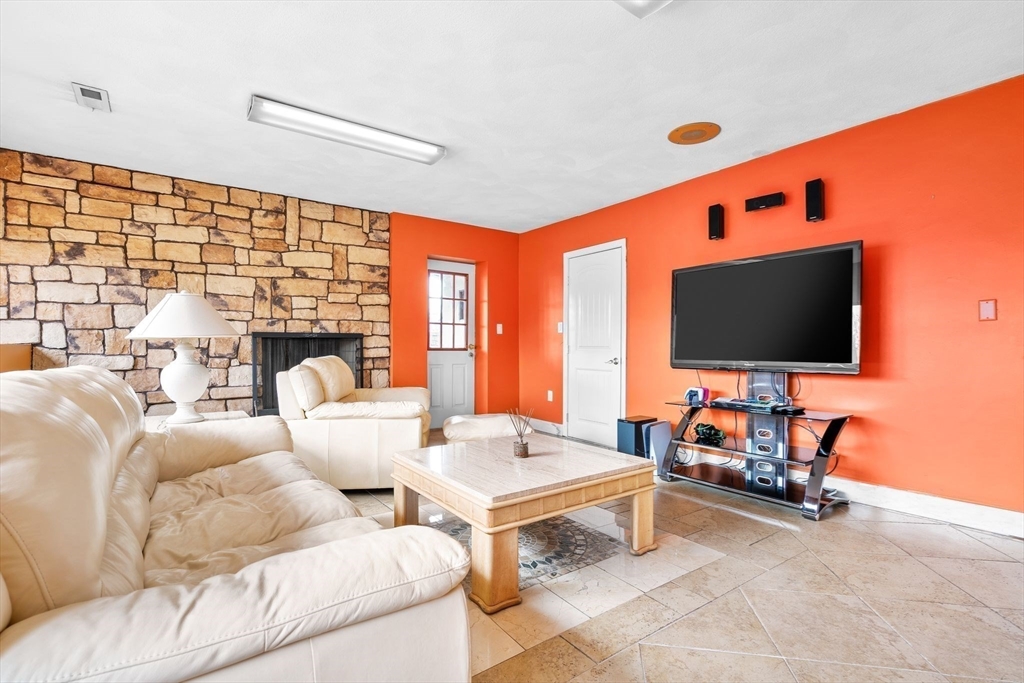 4 Rockland Terrace Saugus, MA 01906 - Photo 32 of 42 a living room with furniture and a flat screen tv
